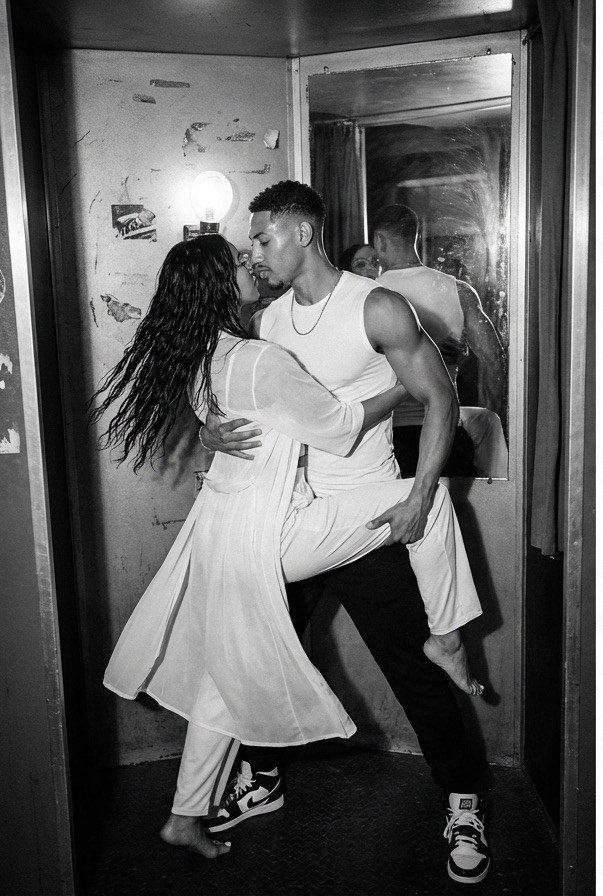 Couple dancing inside a mirror photo booth